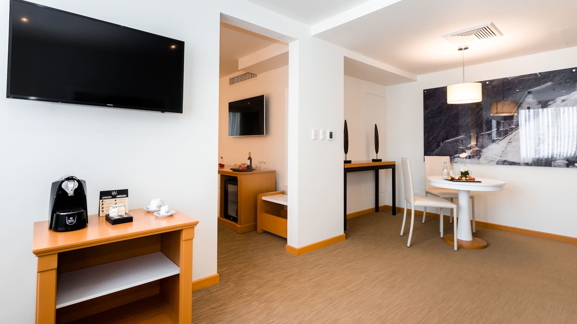 a room with a table and chairs and a television