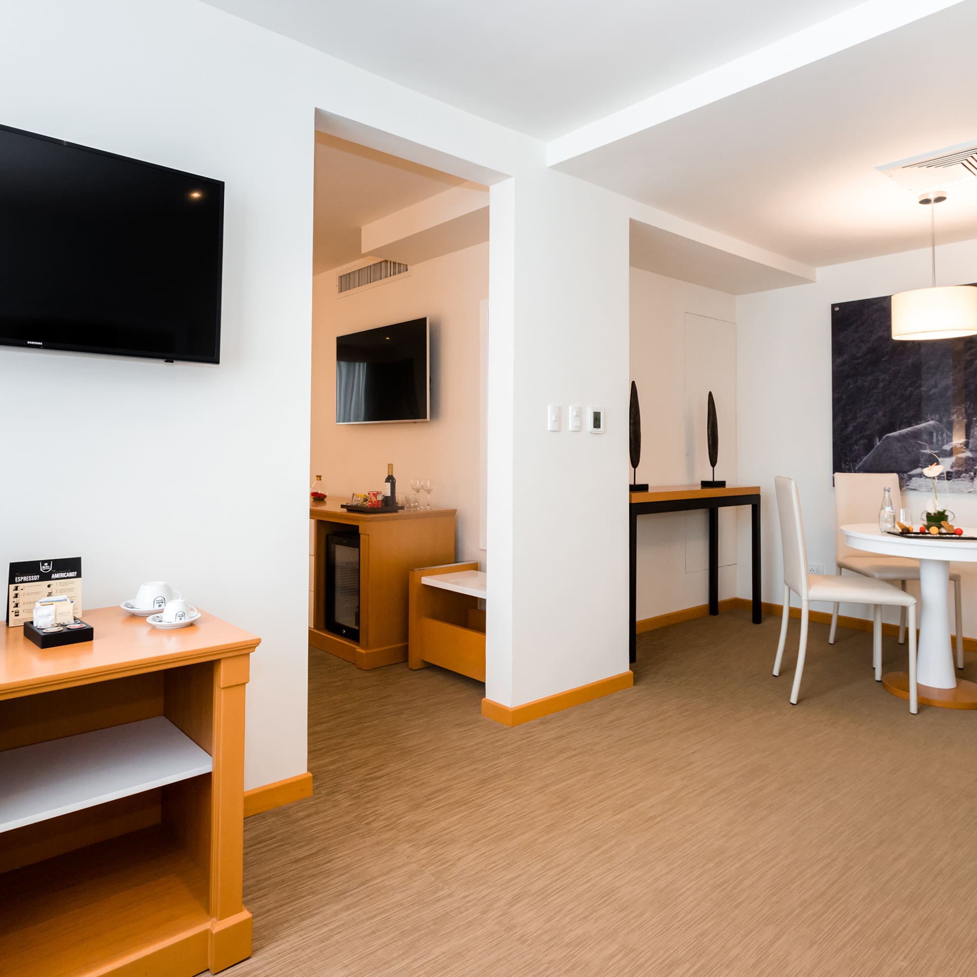 a room with a table and chairs and a television