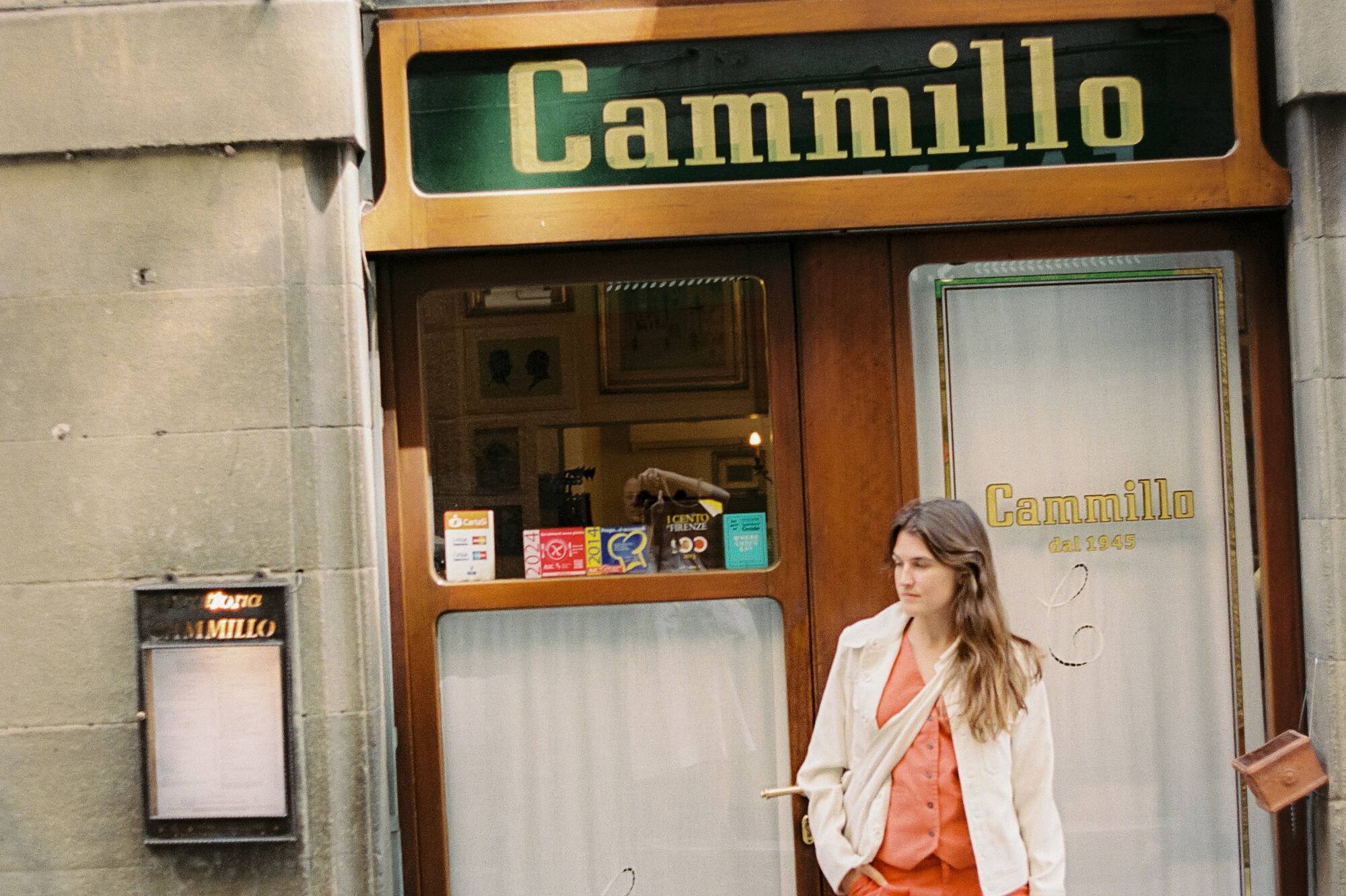 a woman standing in front of a store