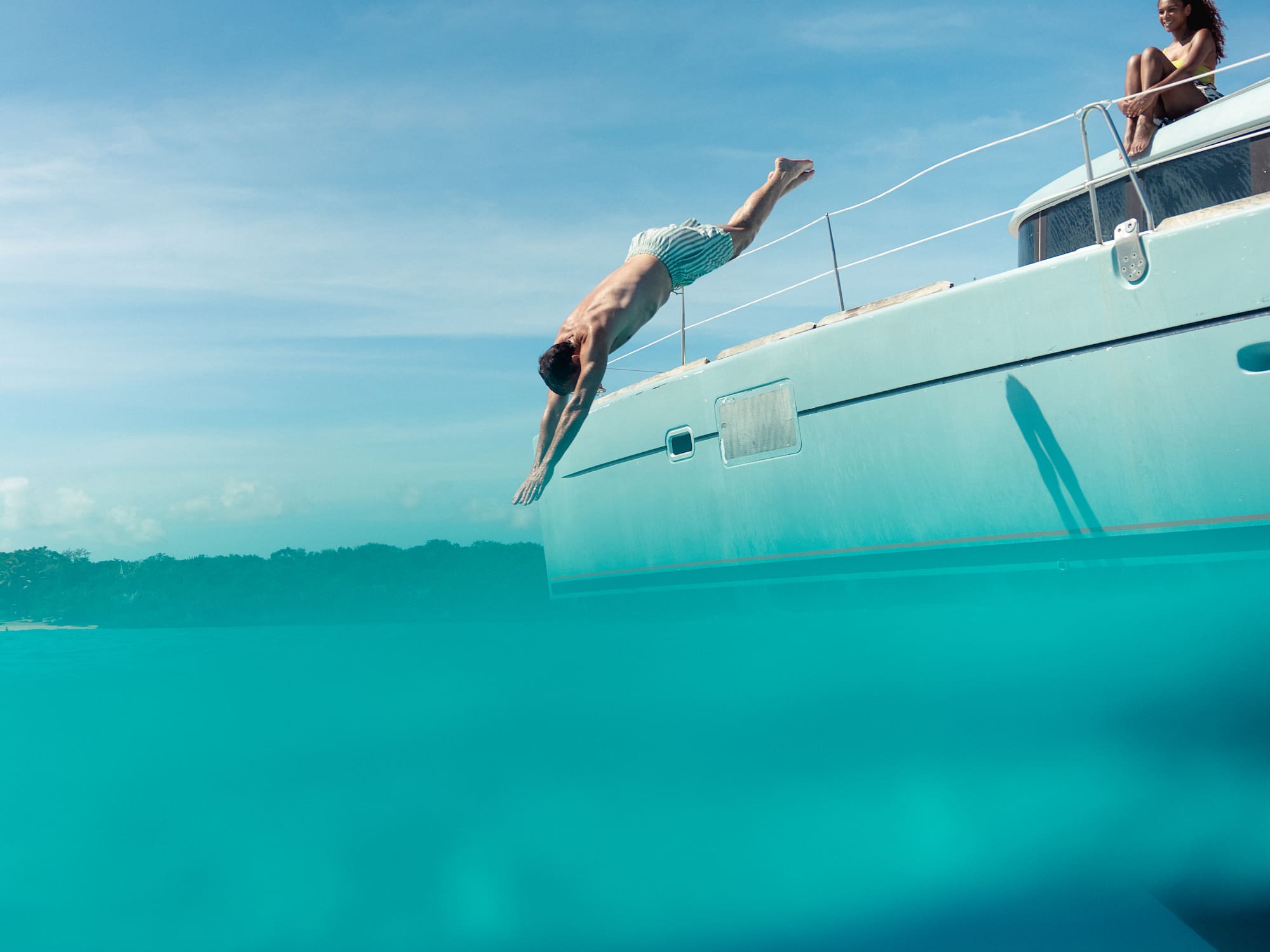 a man diving into a boat