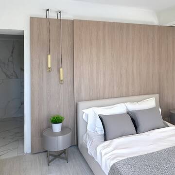 a bedroom with a bed and a plant