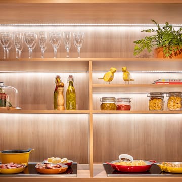 a shelf with food and wine glasses