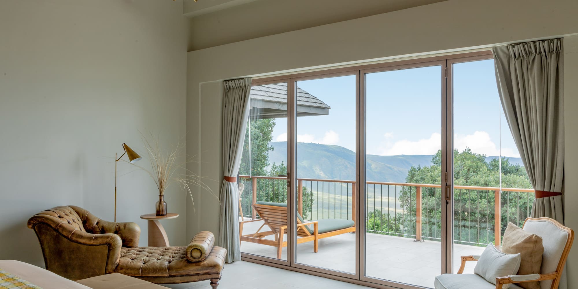 a living room with a glass door and a balcony