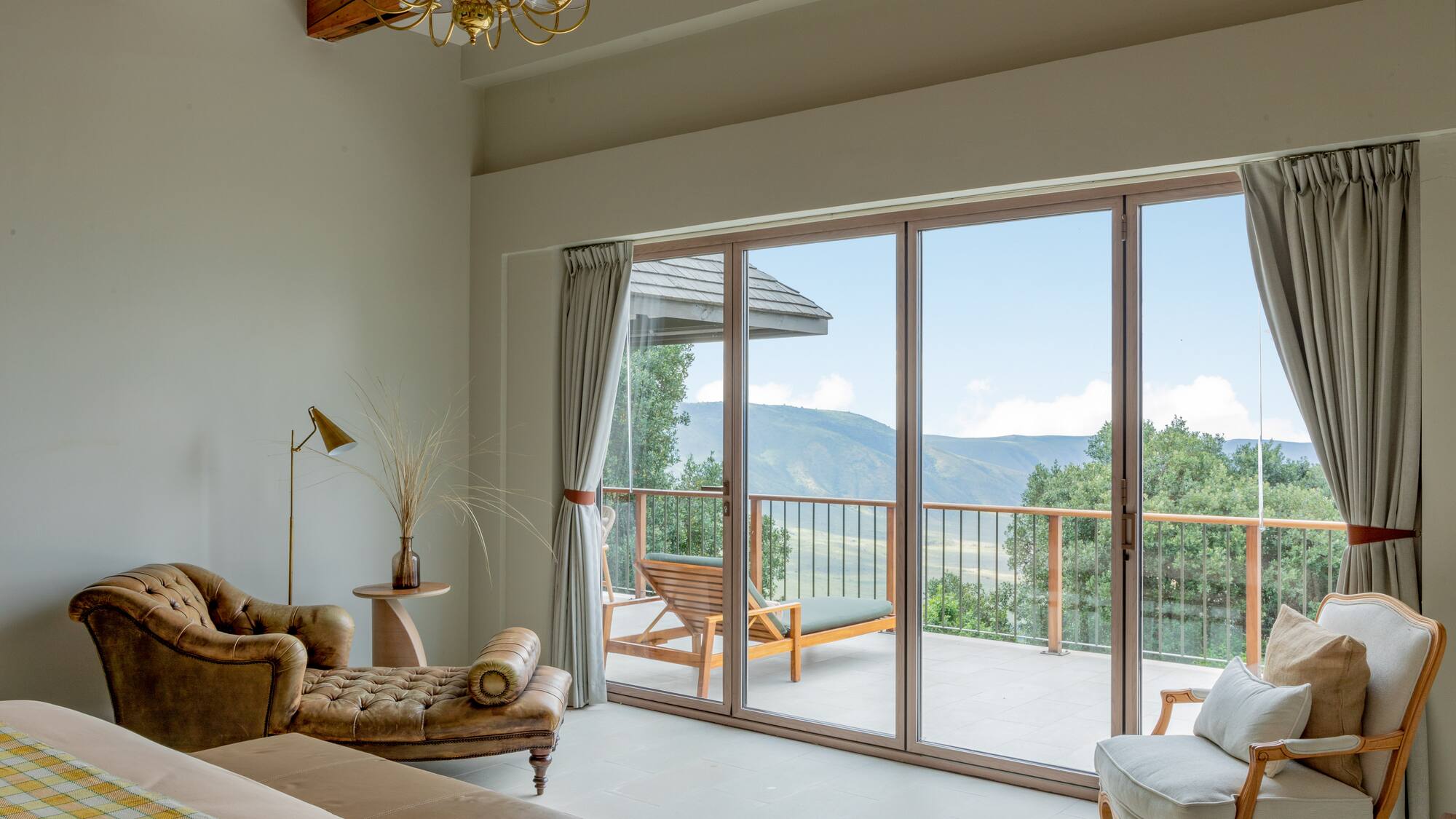 a living room with a glass door and a balcony