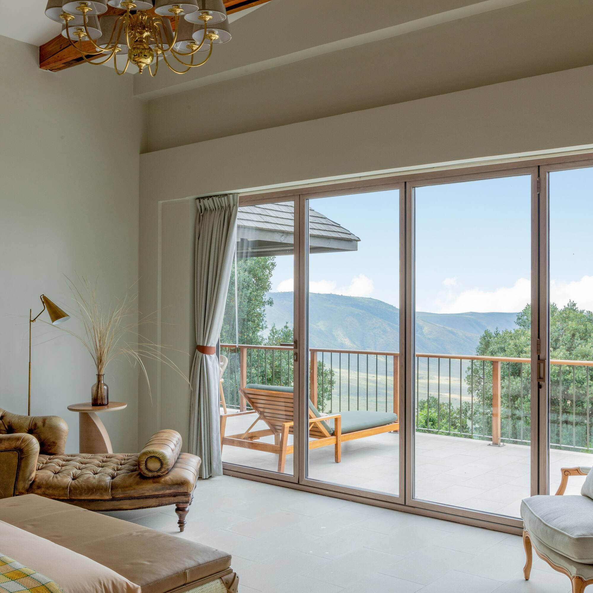 a living room with a glass door and a balcony