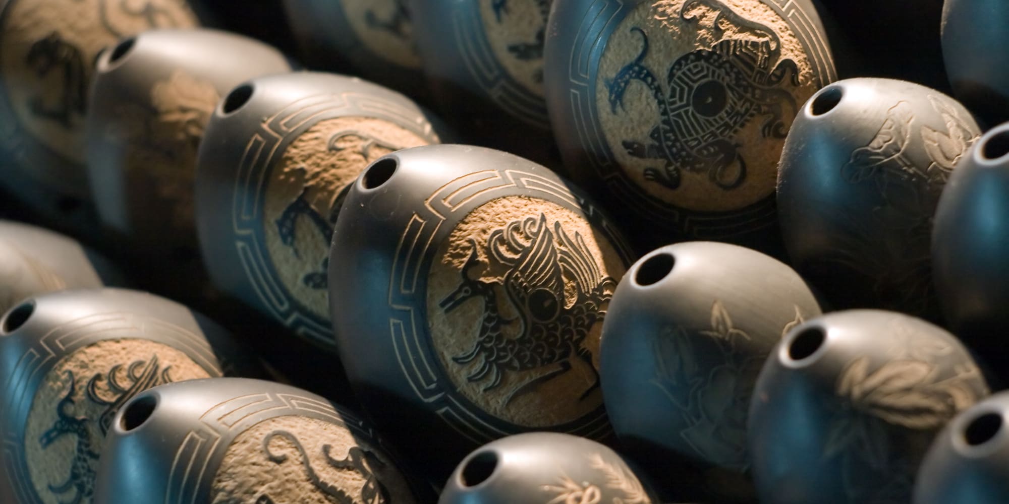 a group of black objects with designs