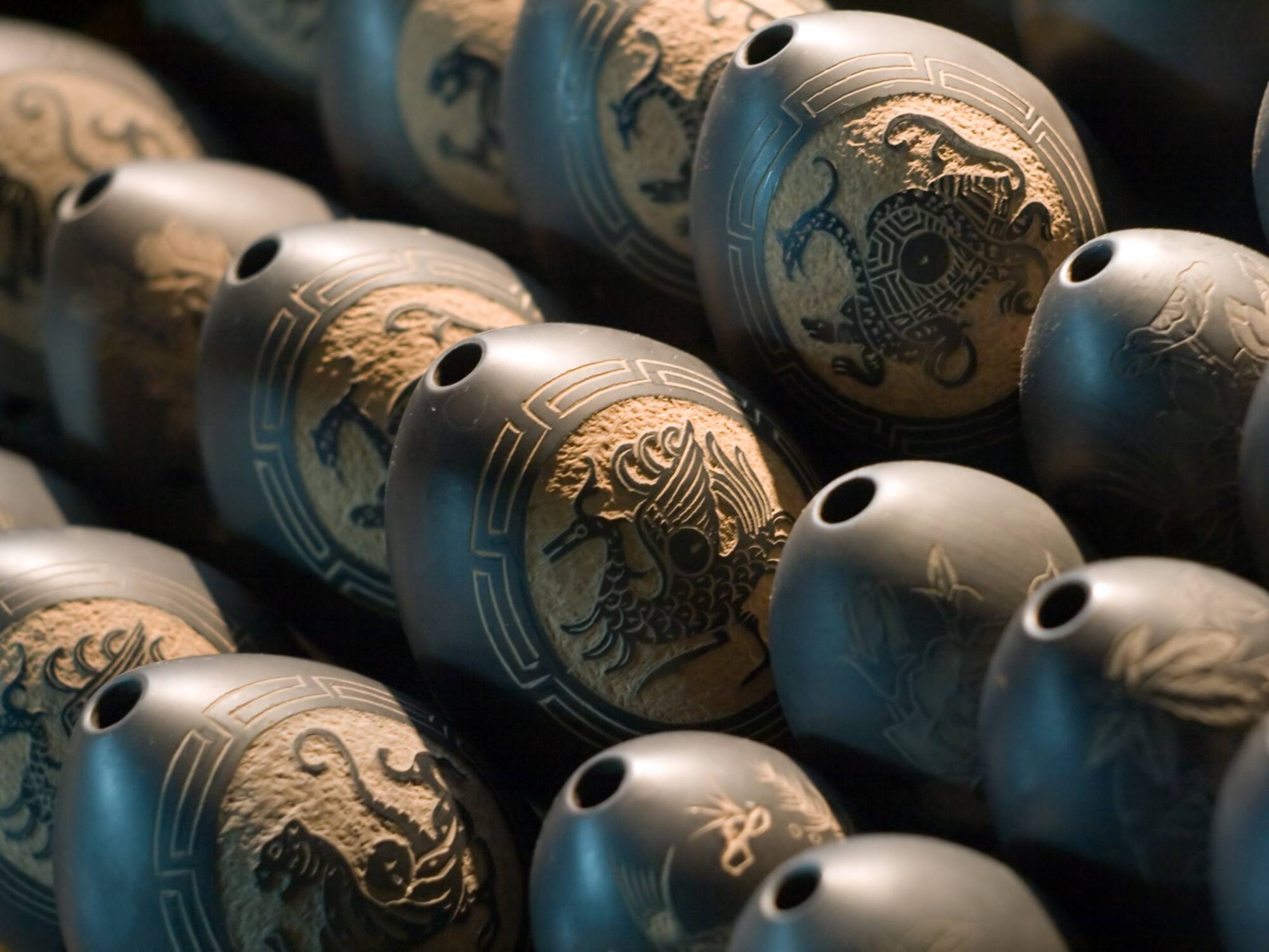 a group of black objects with designs