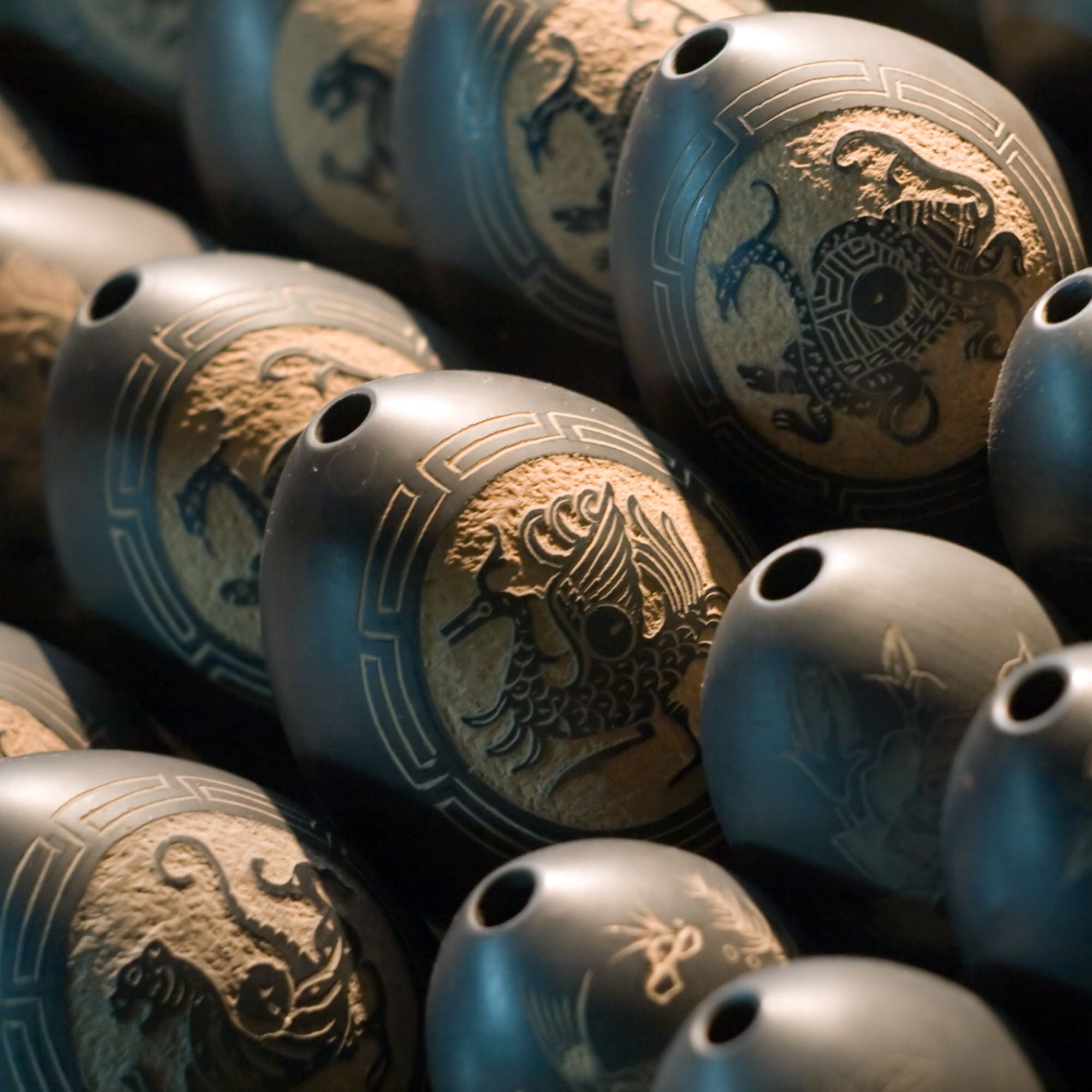 a group of black objects with designs