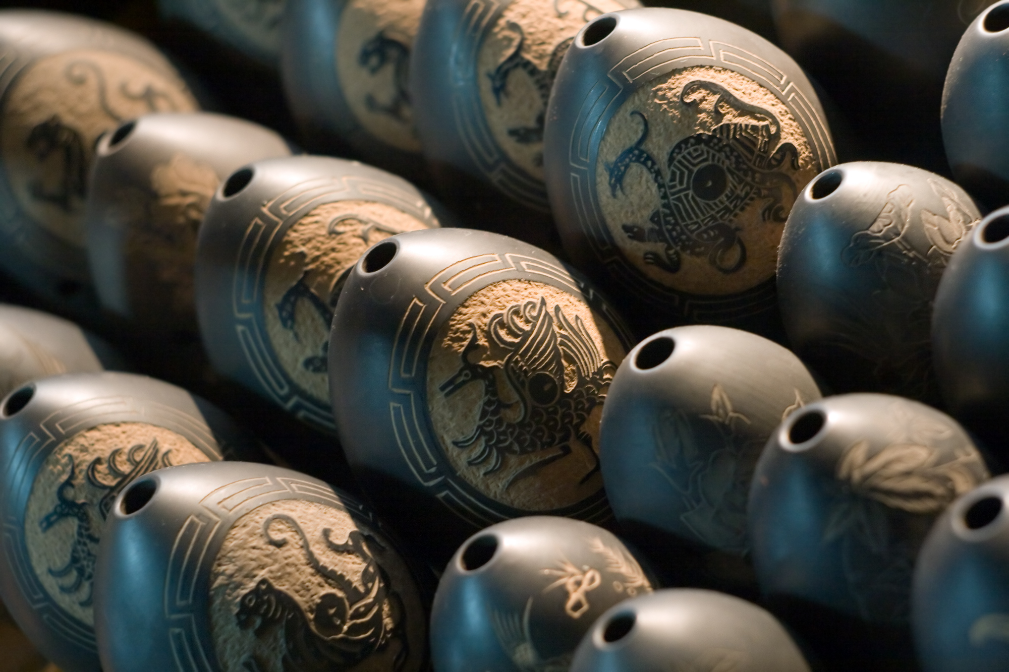 a group of black objects with designs