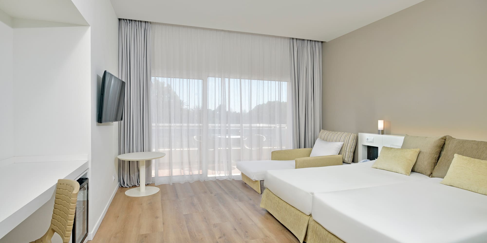 a room with two beds and a television