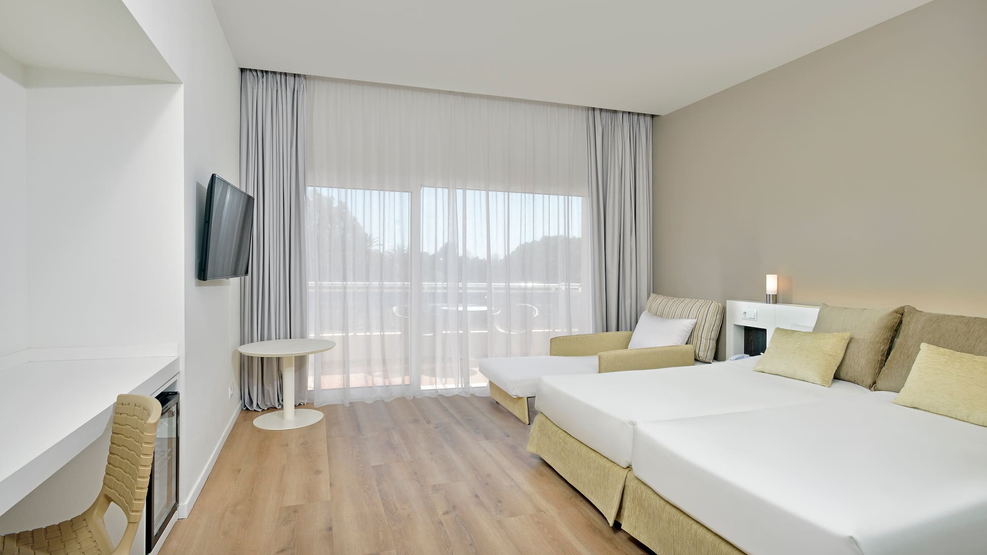 a room with two beds and a television