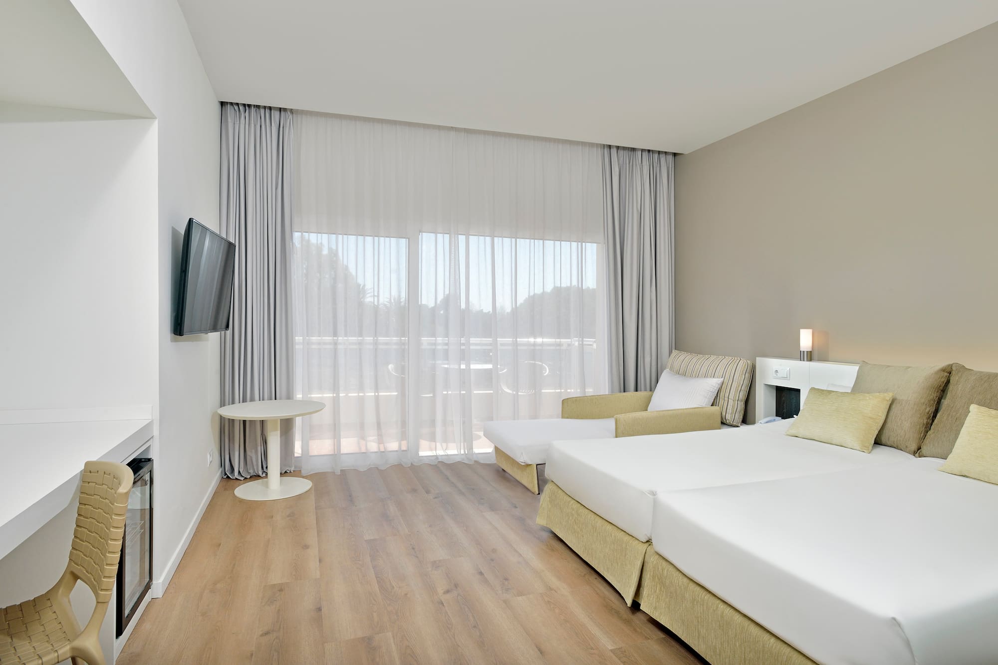 a room with two beds and a television