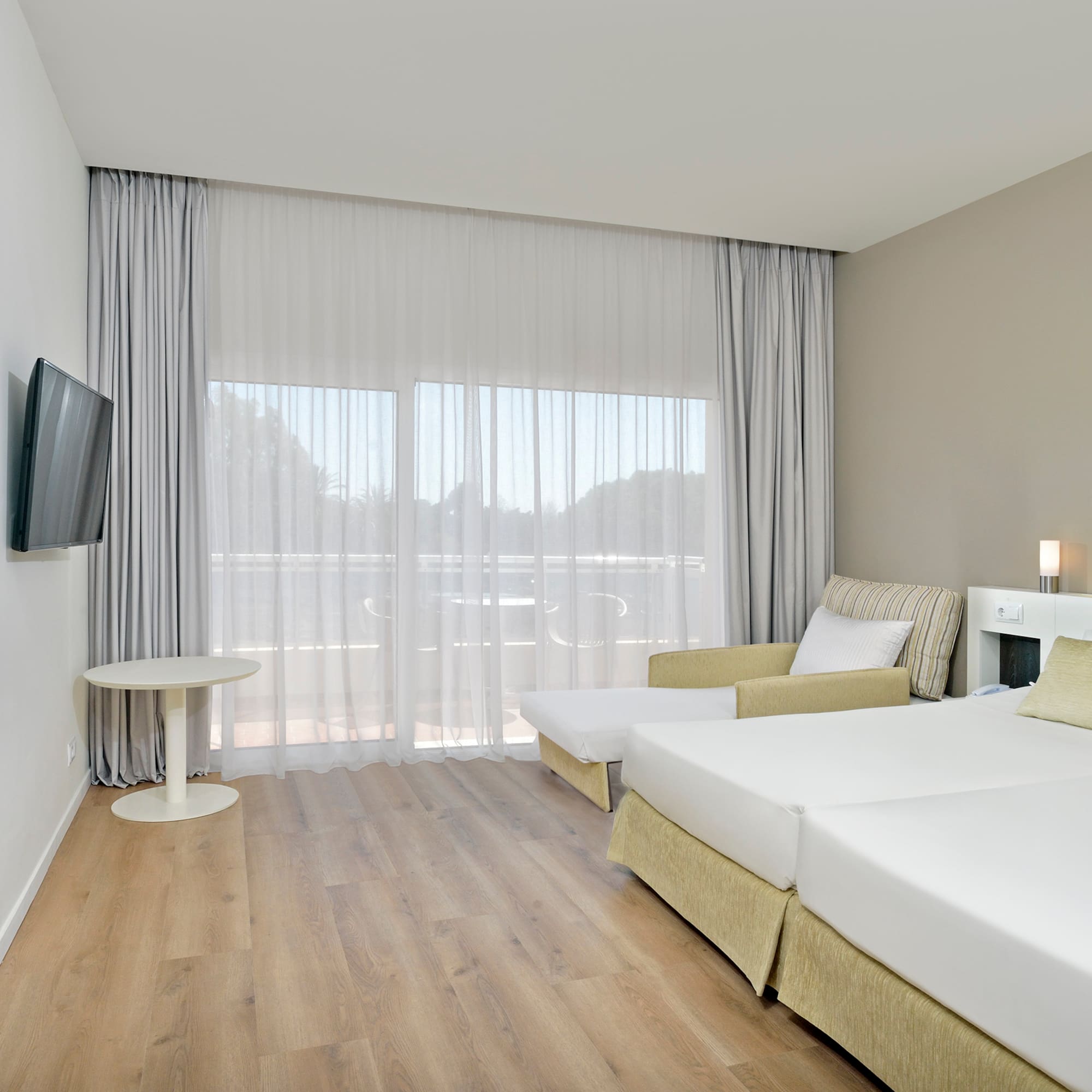 a room with two beds and a television