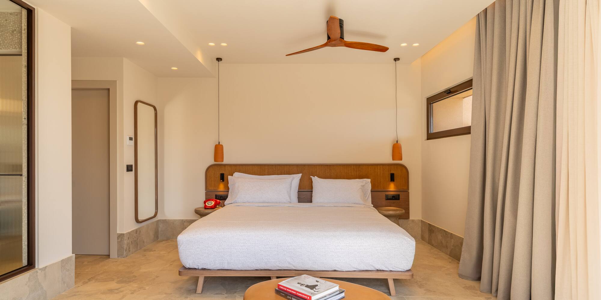 a room with a bed and a fan