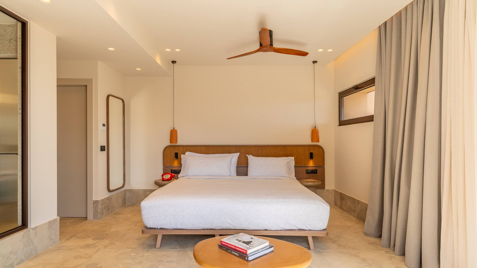 a room with a bed and a fan