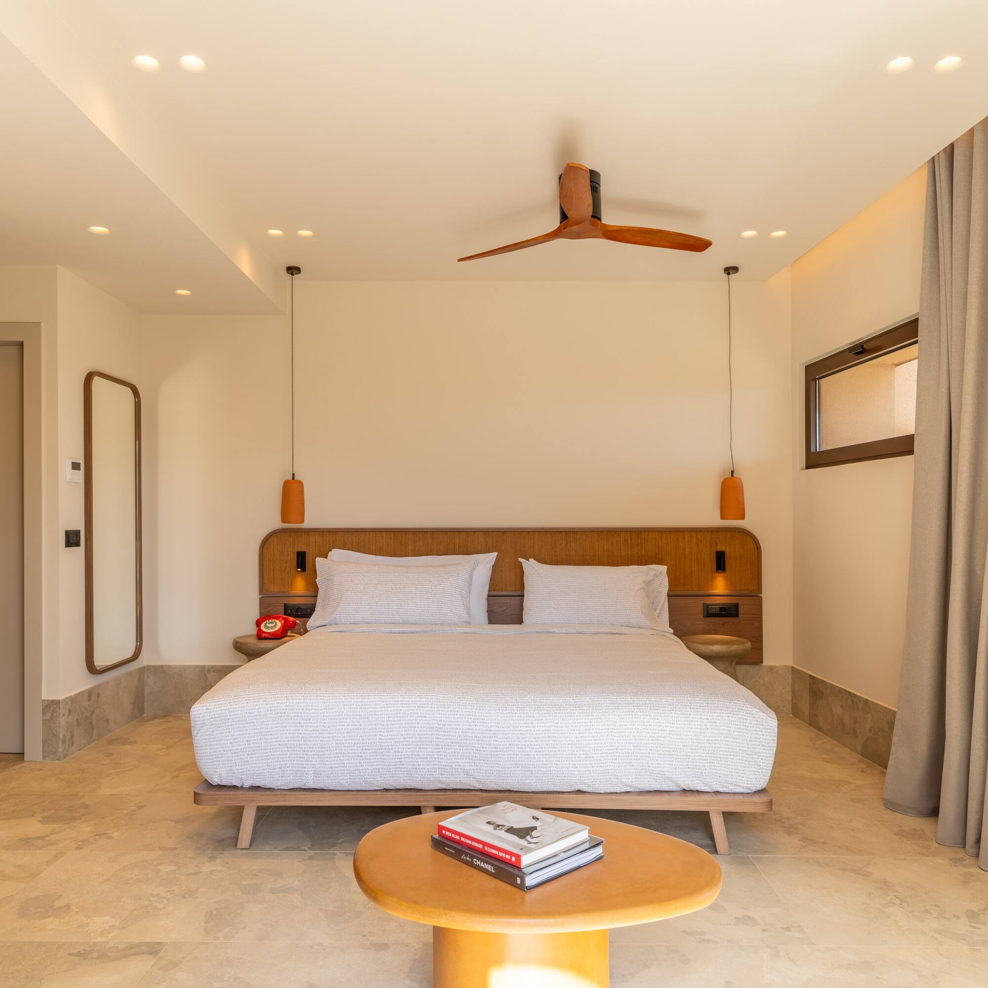 a room with a bed and a fan