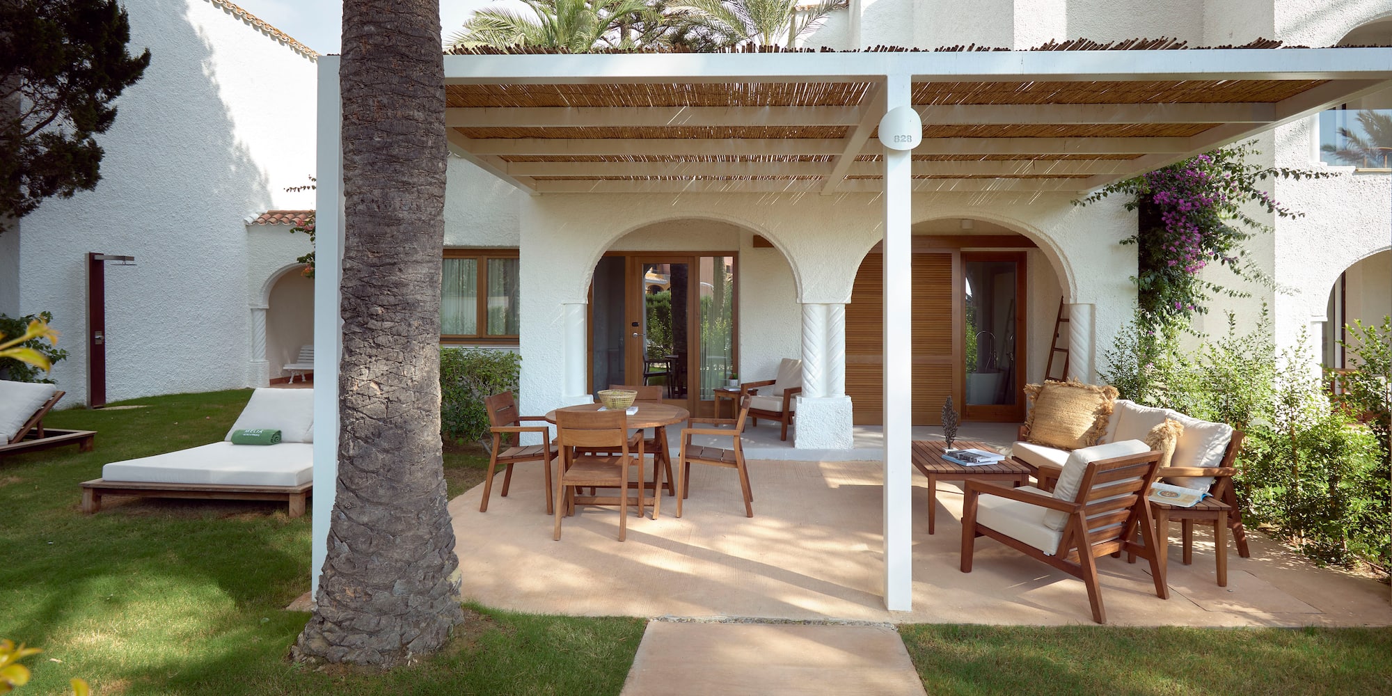 a patio with a covered patio and a tree