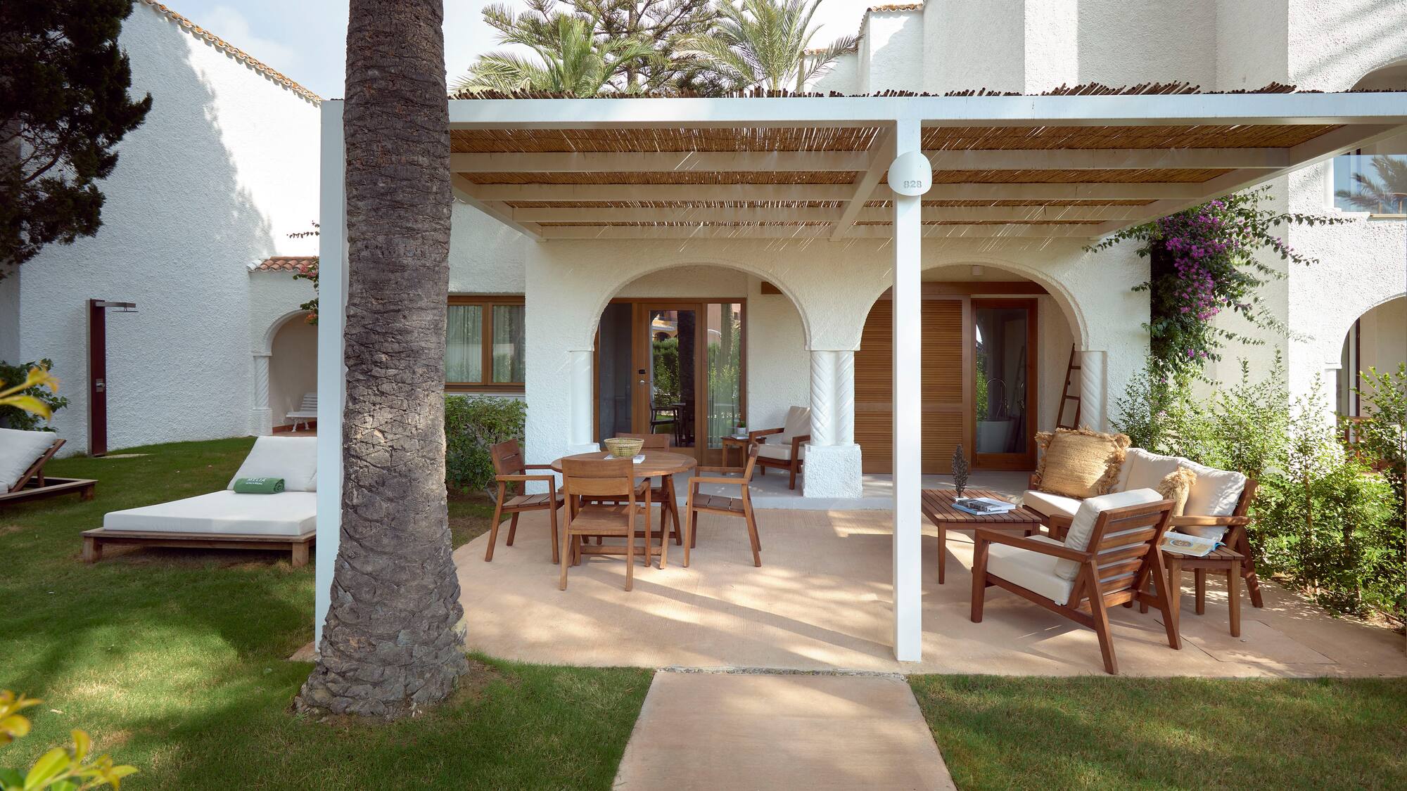 a patio with a covered patio and a tree