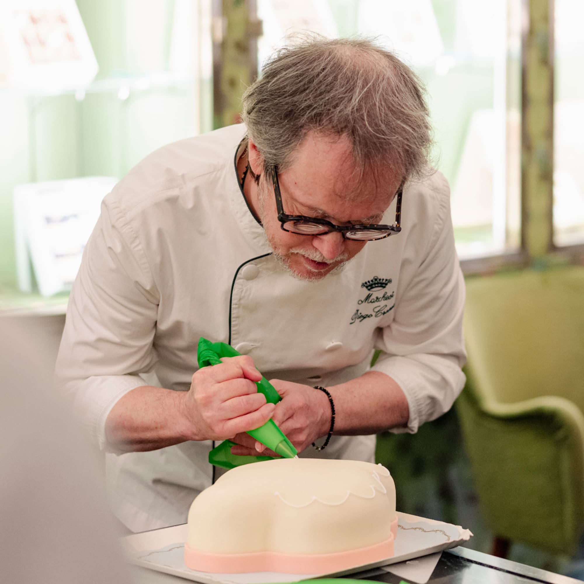 a man decorating a cake