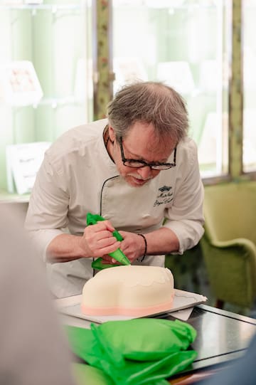 a man decorating a cake