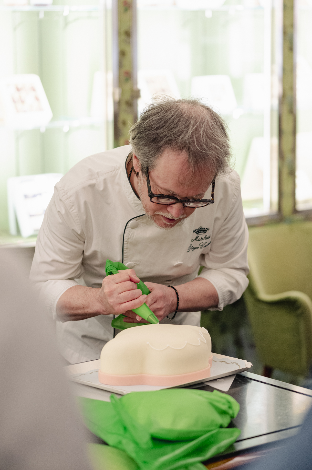 a man decorating a cake