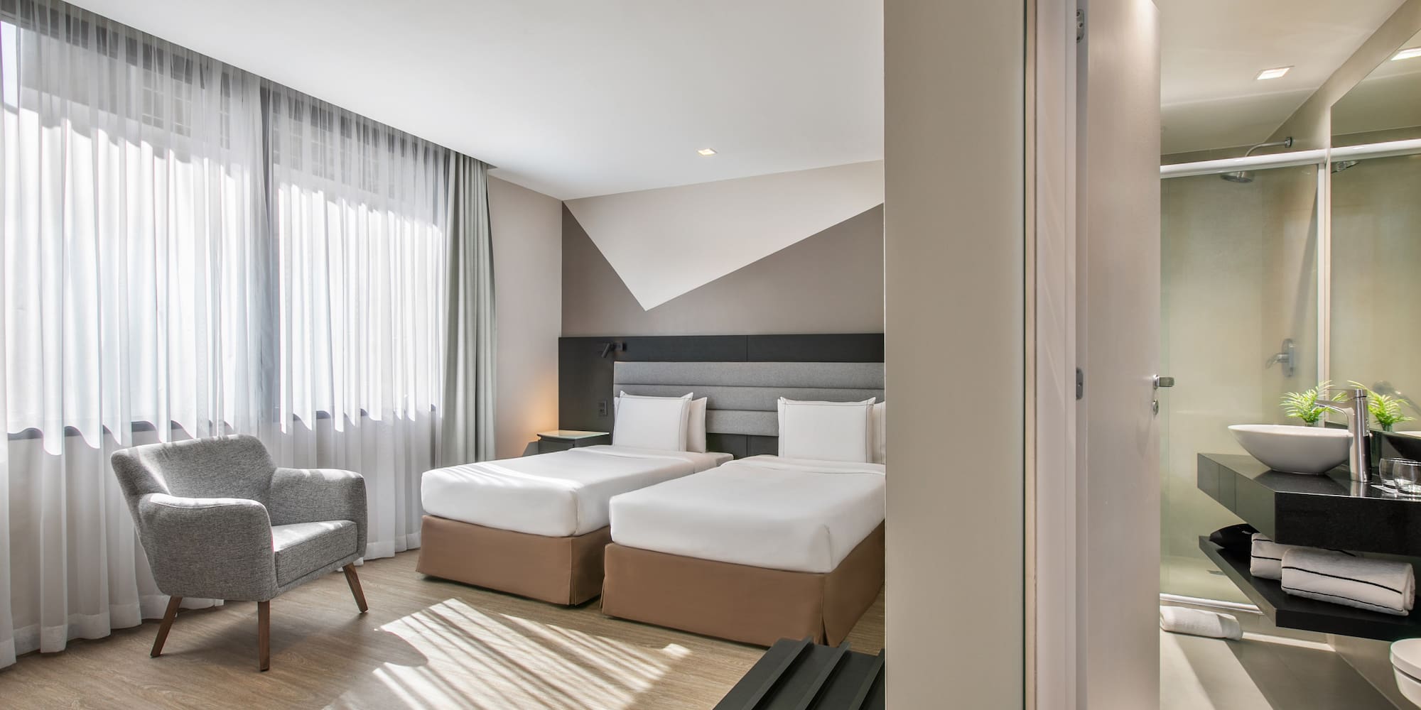 a room with two beds and a chair