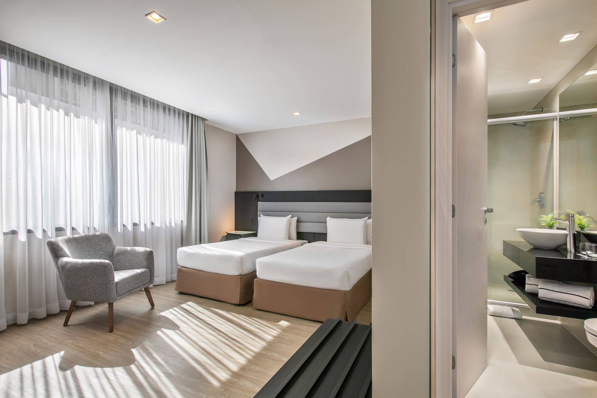 a room with two beds and a chair