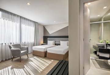 a room with two beds and a chair