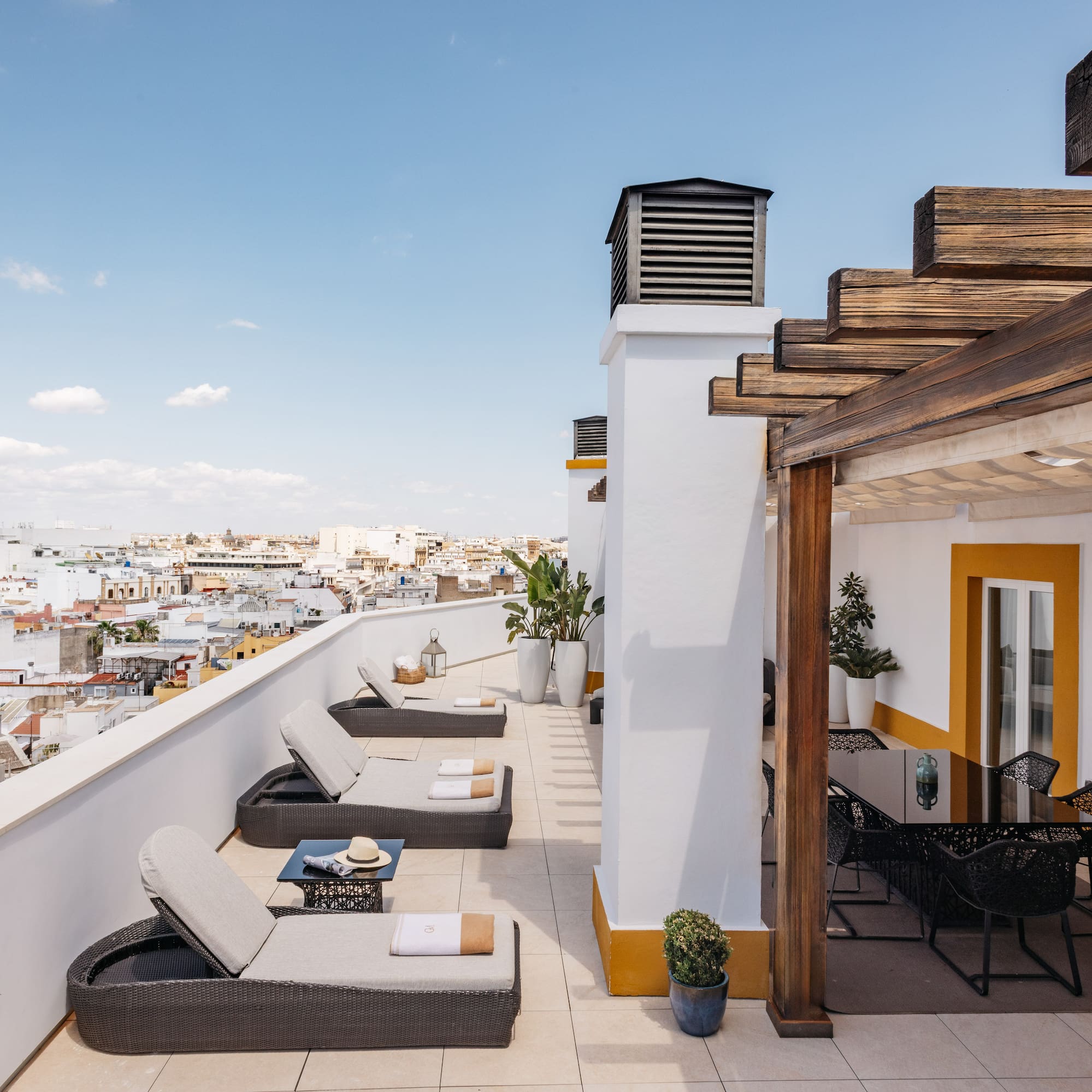 a patio with chairs and a view of the city