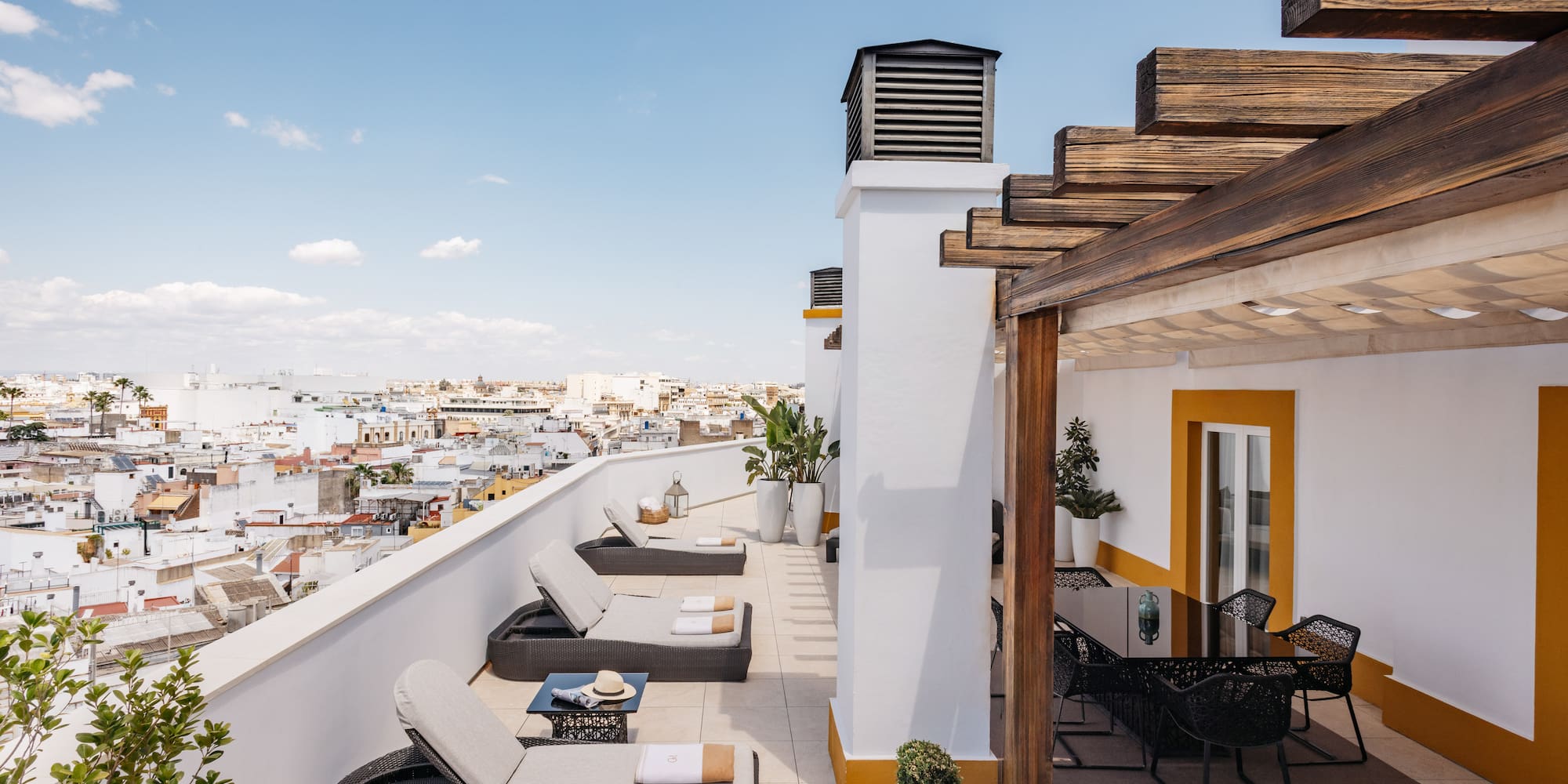 a patio with chairs and a view of the city