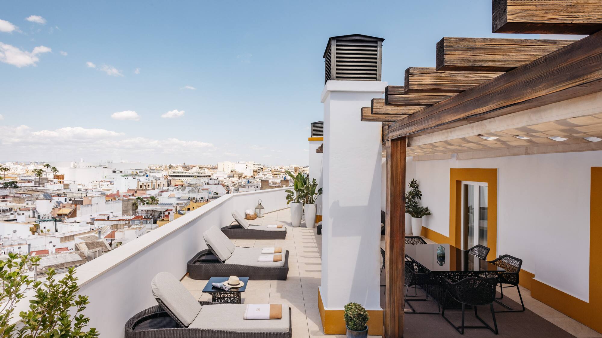 a patio with chairs and a view of the city