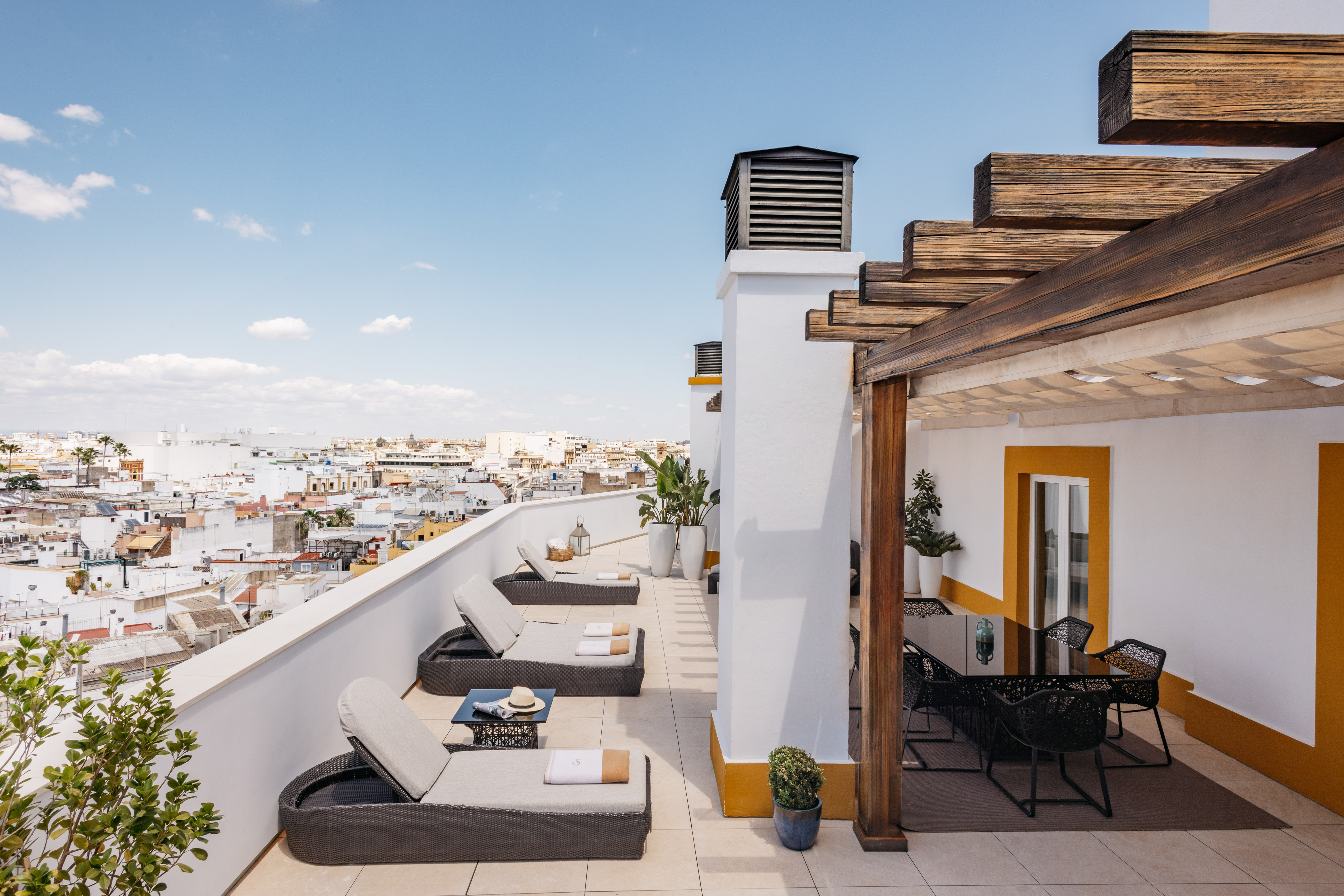 a patio with chairs and a view of the city
