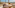 Beachfront dining terrace with sea view, sandy beach, and straw parasols.