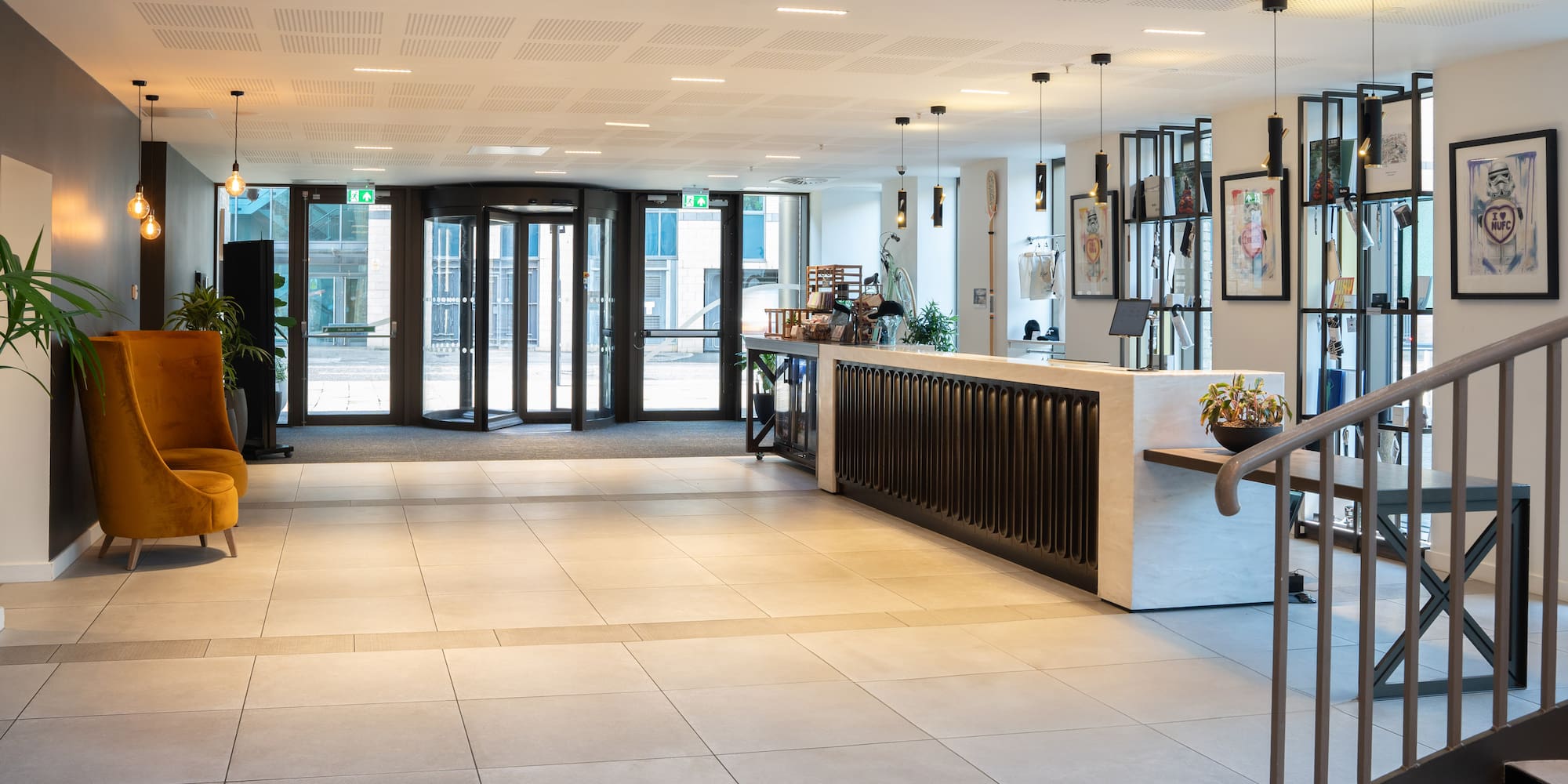 a lobby with a reception desk and glass doors