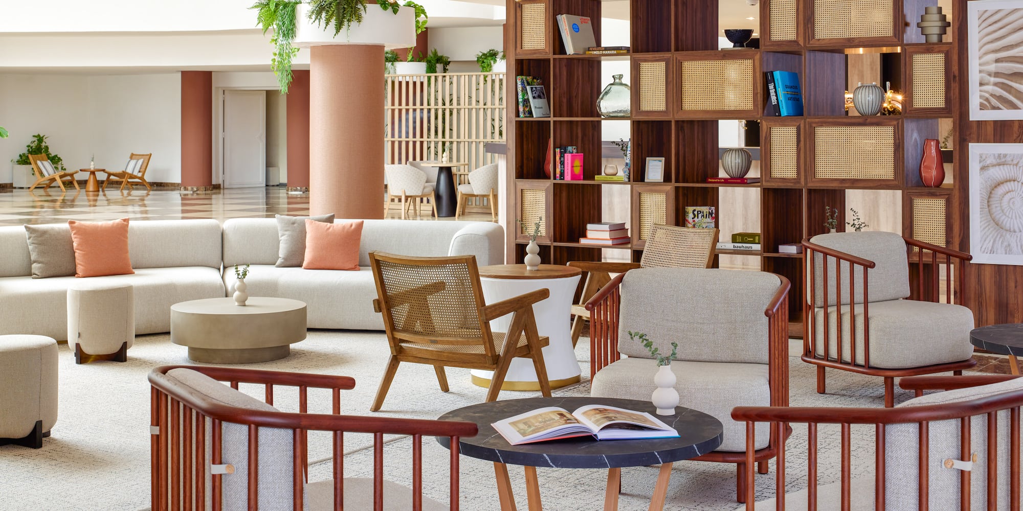 a room with a large bookcase and chairs