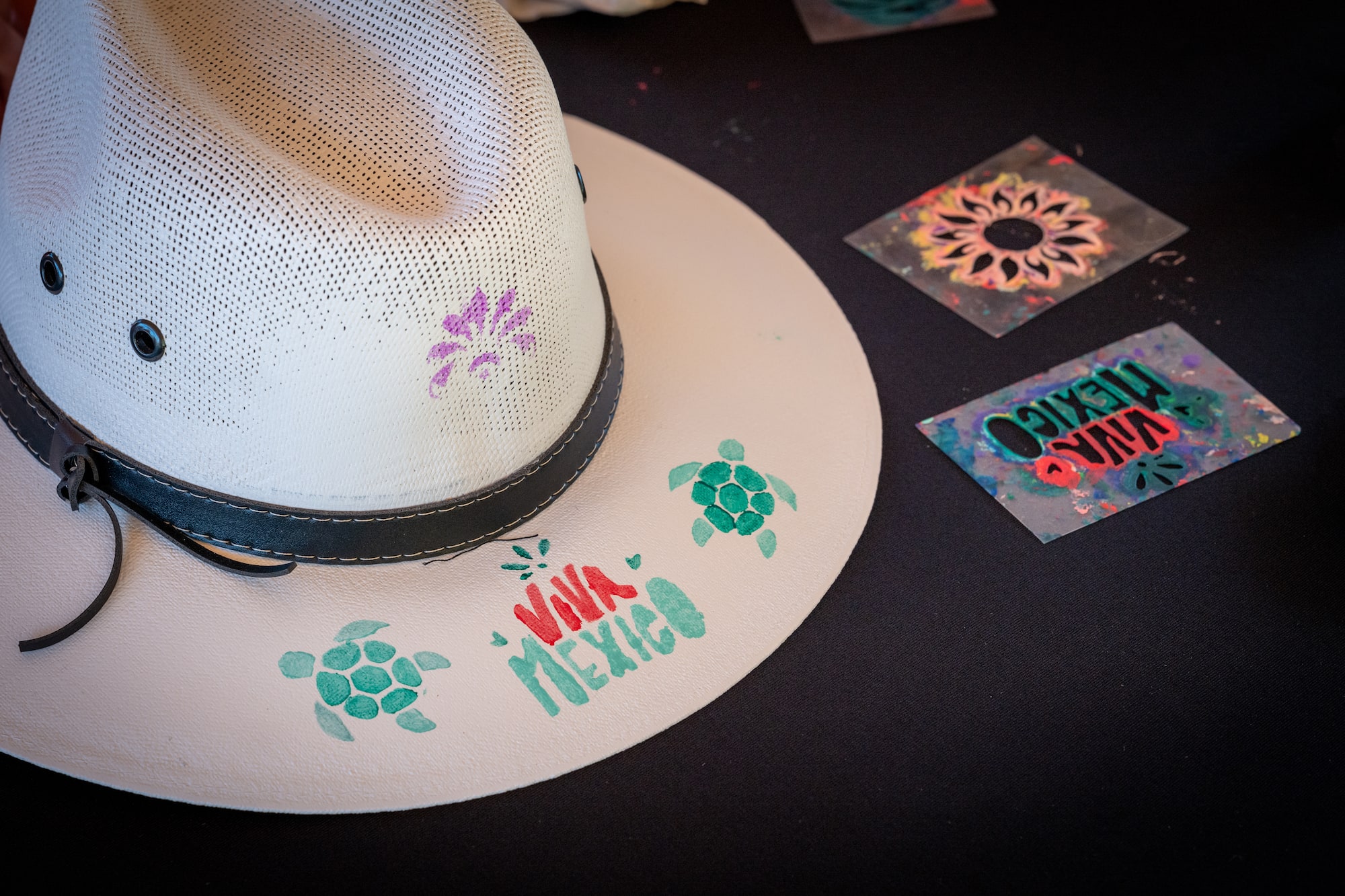 a hat with a black band and several stickers