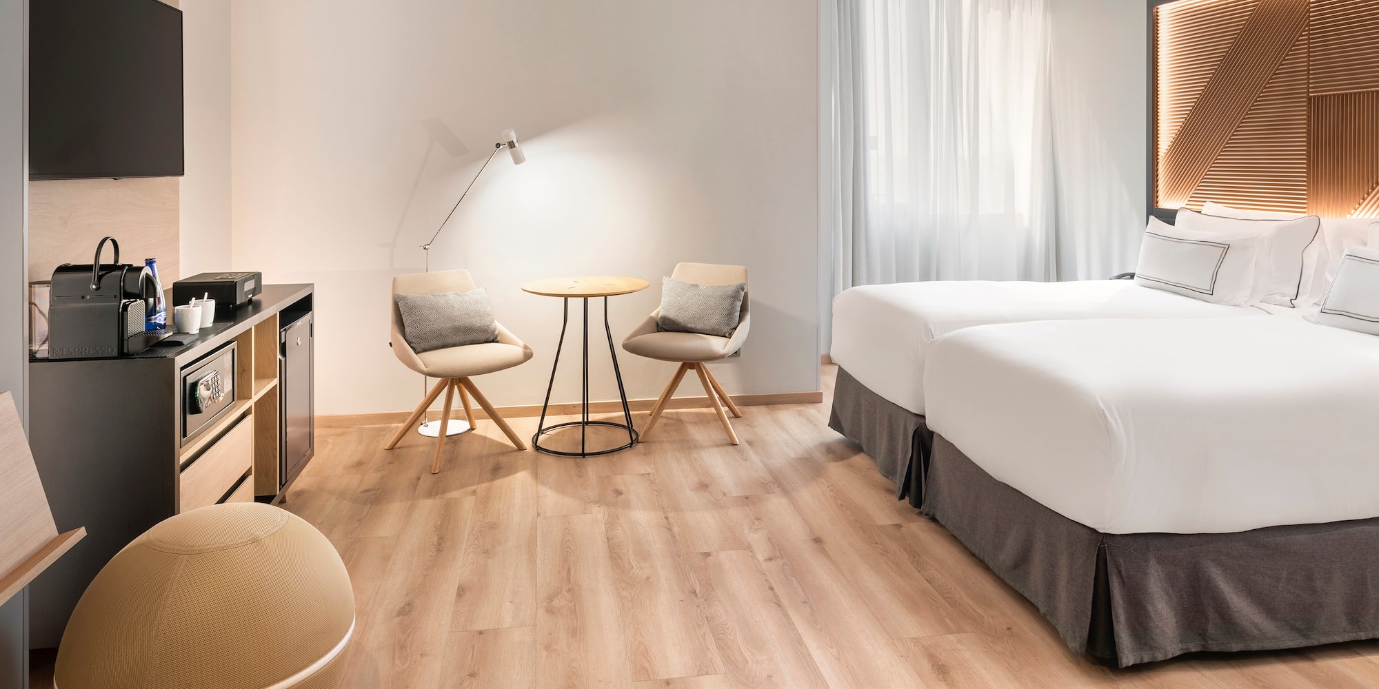 a room with two beds and a table