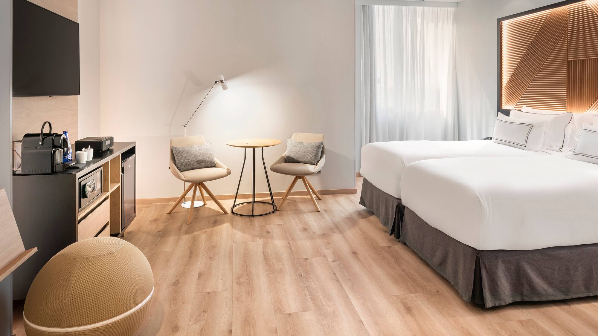 a room with two beds and a table