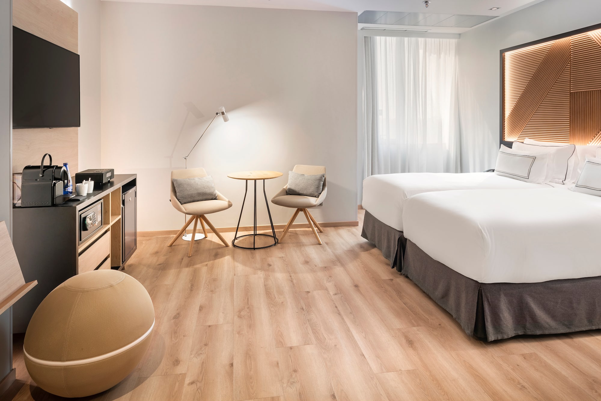 a room with two beds and a table