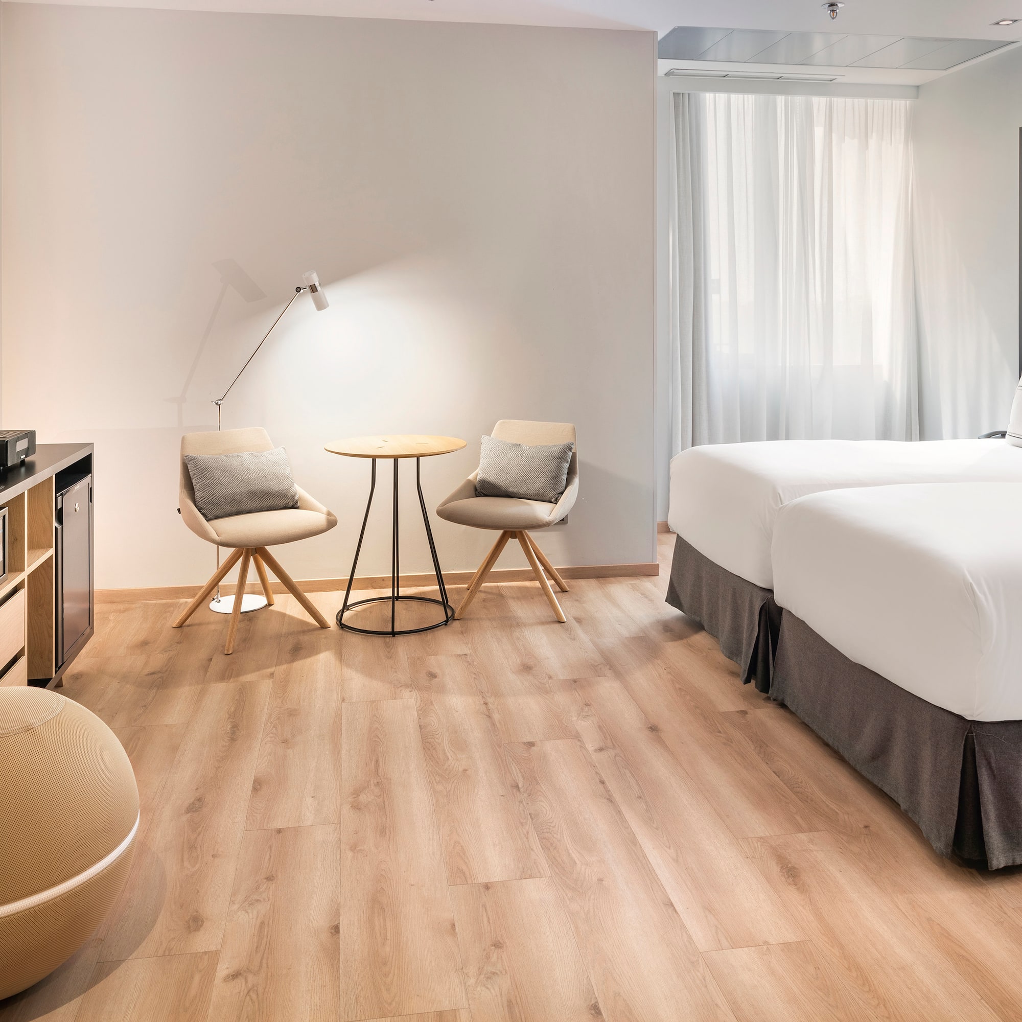 a room with two beds and a table