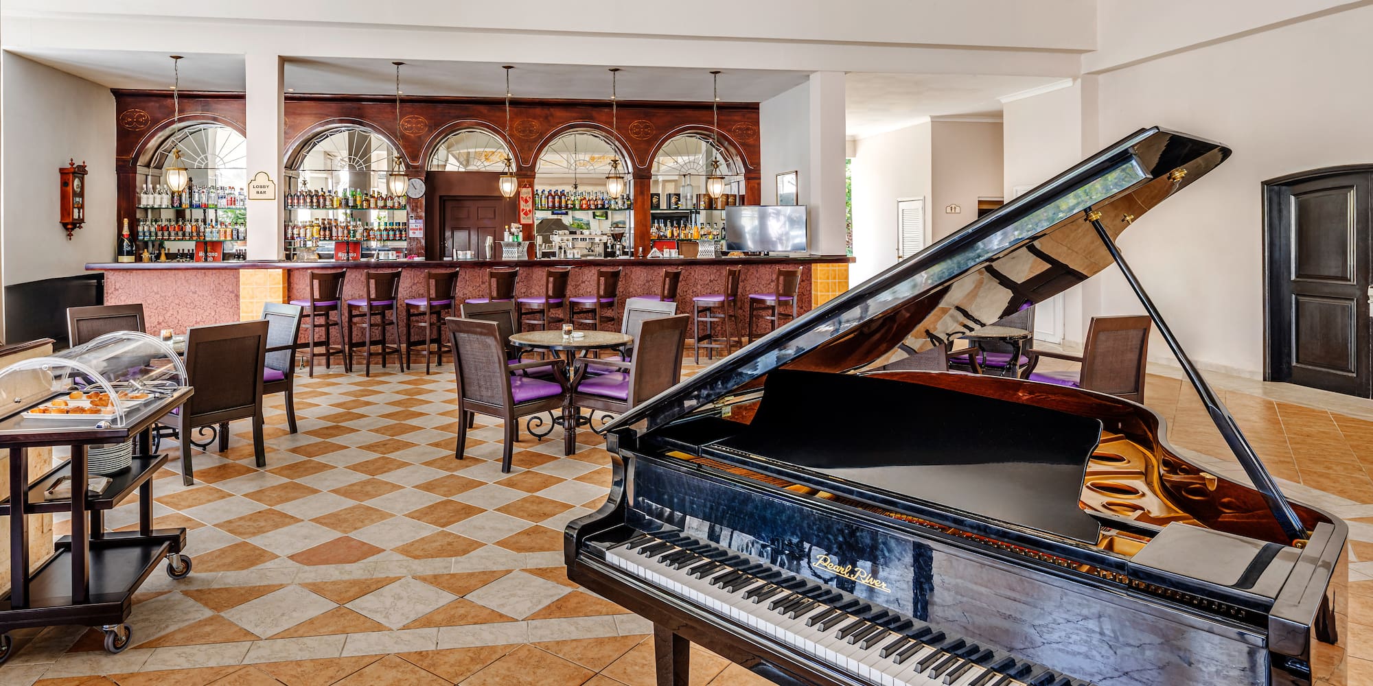 a piano in a room with tables and chairs