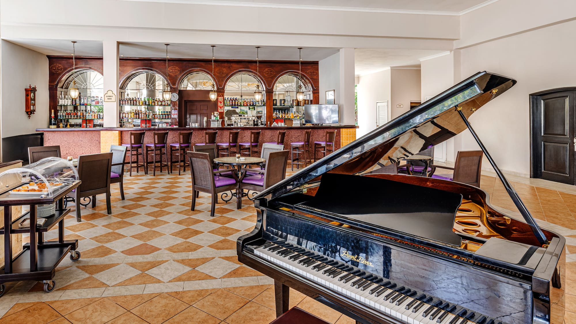a piano in a room with tables and chairs