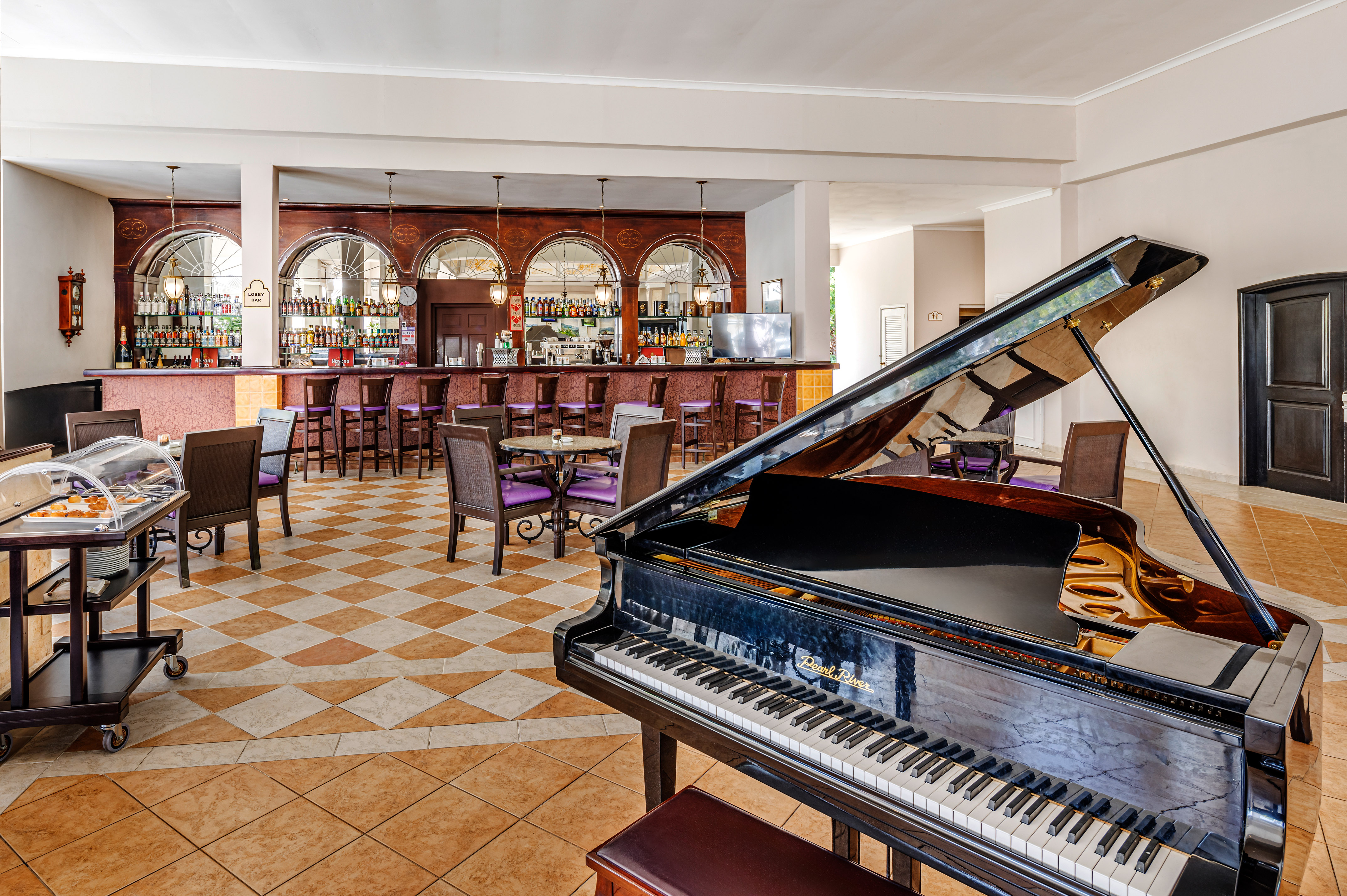 a piano in a room with tables and chairs