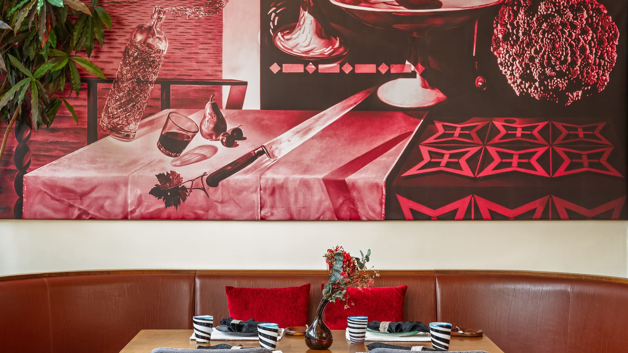 a table with chairs and a painting on the wall