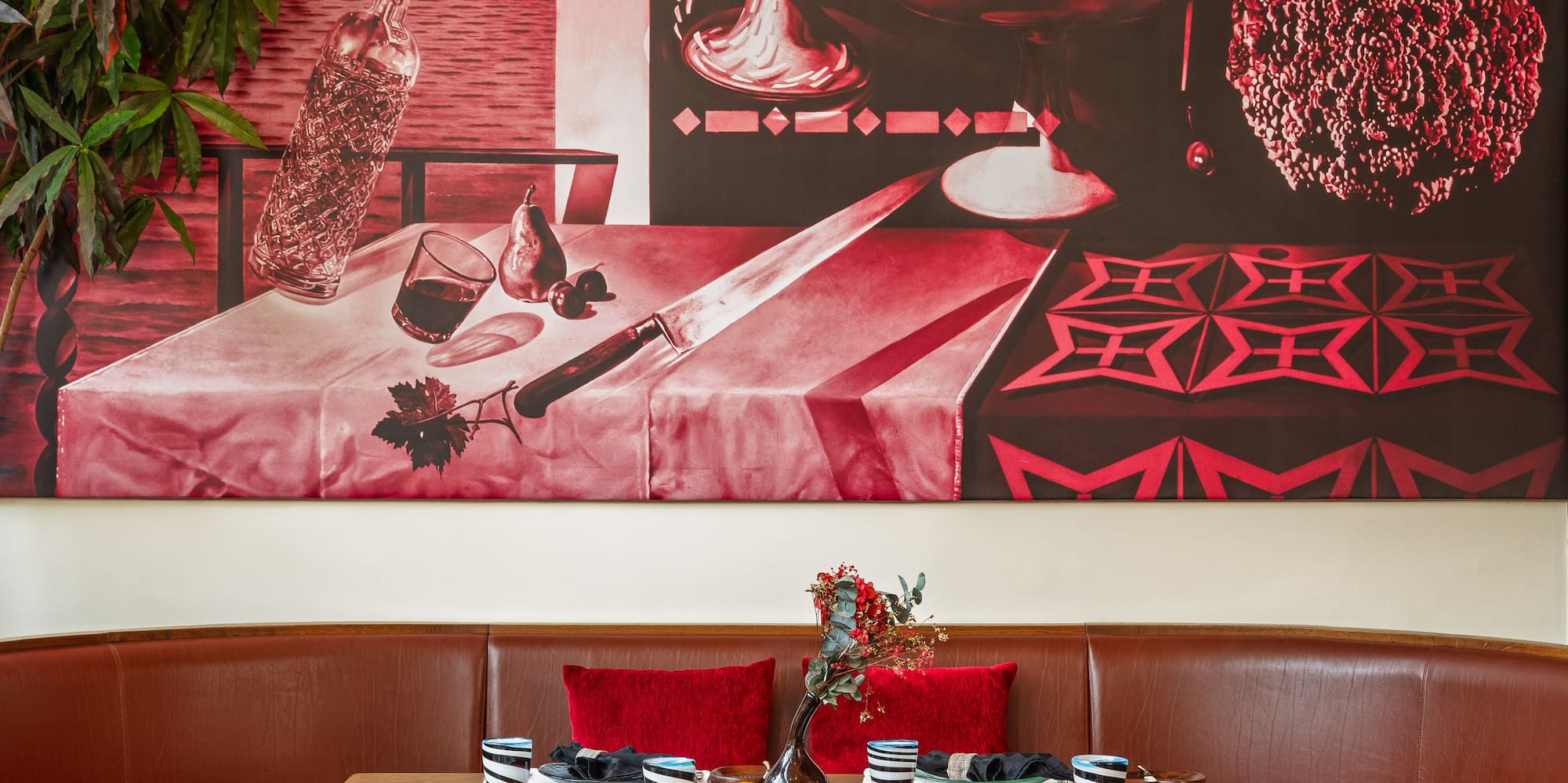 a table with chairs and a painting on the wall