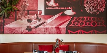 a table with chairs and a painting on the wall