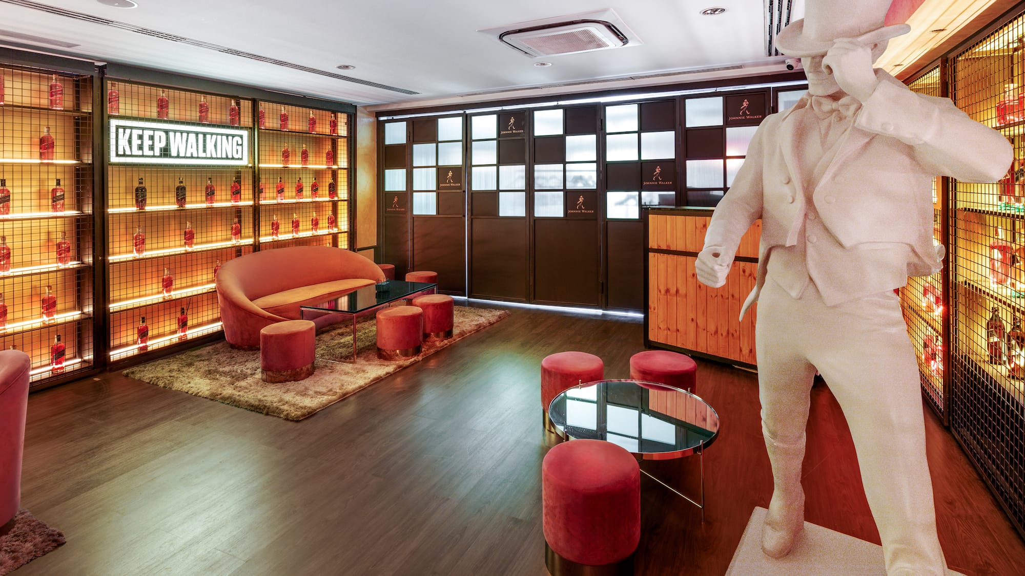 a room with a statue and a table and chairs