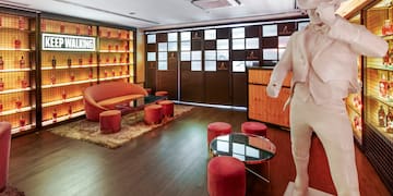 a room with a statue and a table and chairs