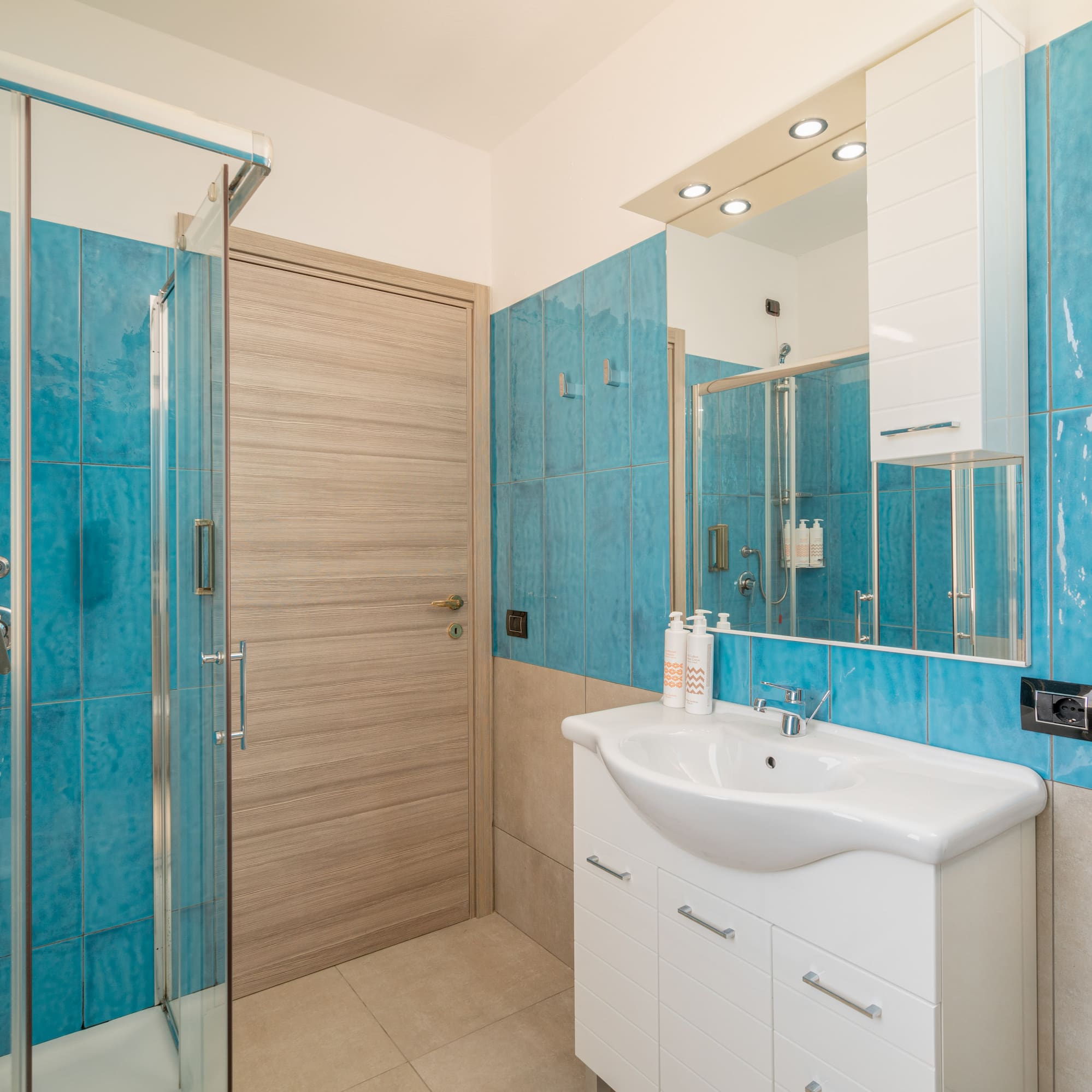 a bathroom with blue tiles