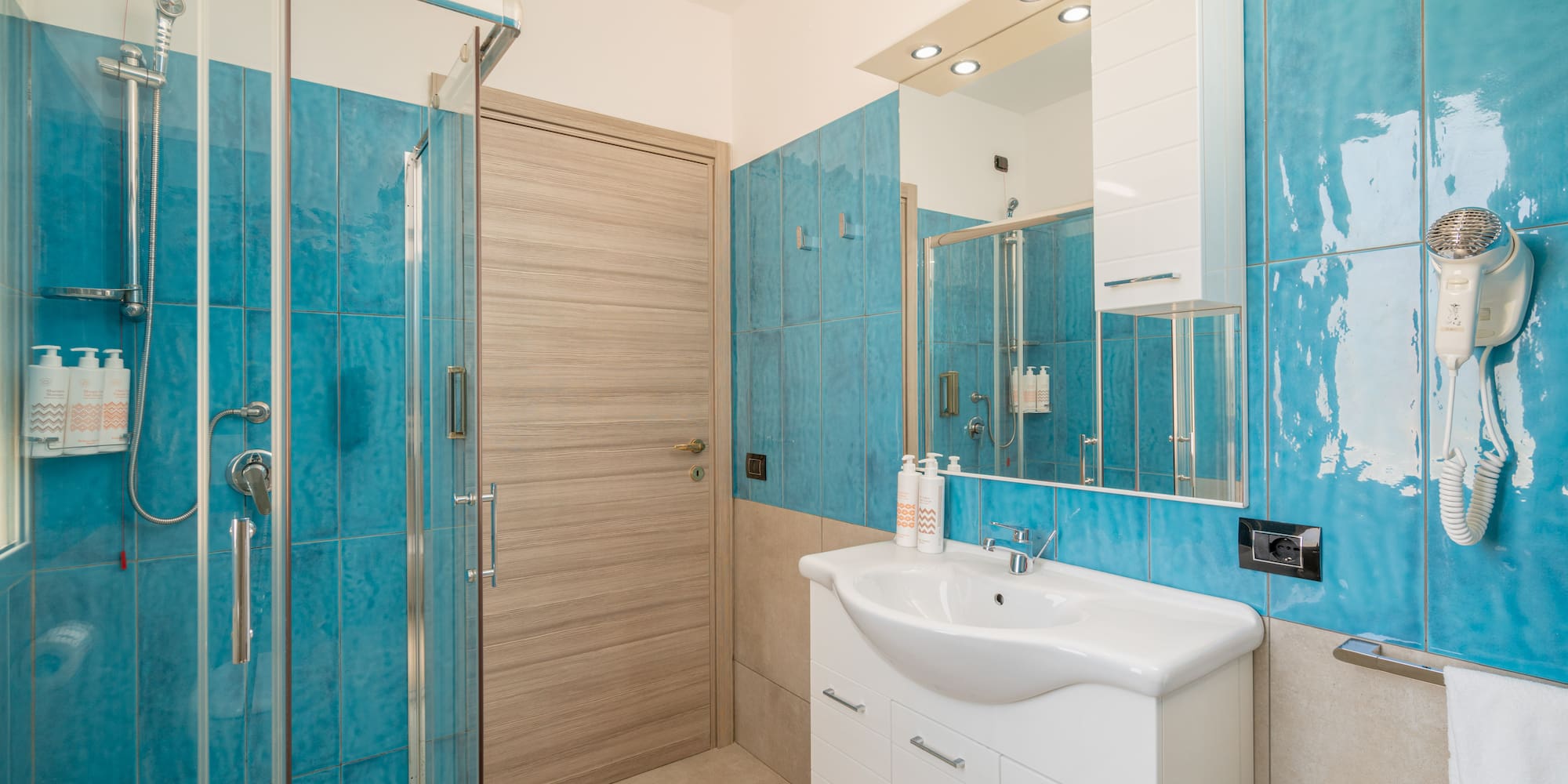 a bathroom with blue tiles